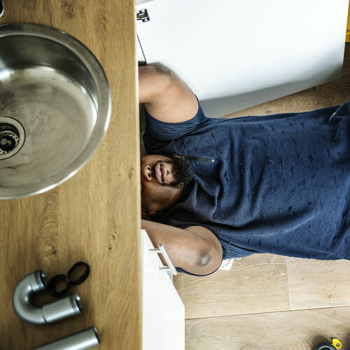 Man Fixing Kitchen Sink Man Fixing Kitchen Sink