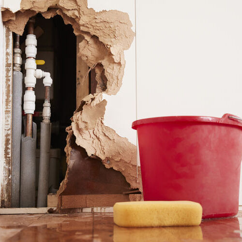Damaged Wall Exposed Burst Water Pipes Sponge And Bucket Damaged Wall Exposed Burst Water Pipes Sponge And Bucket